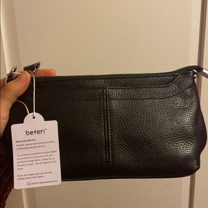 Strapped small black faux leather purse